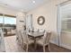 Open dining area with views of a waterfront patio area with table and seating is a bonus at 3036 Parrot Head Pl, Kissimmee, FL 34747
