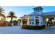 Welcome to this property entrance with lush greenery, palm trees, and access control at 3036 Parrot Head Pl, Kissimmee, FL 34747