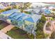 Exterior aerial view of a building surrounded by tropical landscaping and mature palm trees at 3036 Parrot Head Pl, Kissimmee, FL 34747