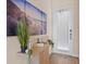 Bright foyer featuring a console table with decor and plants, set against a wall with beach themed artwork at 3036 Parrot Head Pl, Kissimmee, FL 34747