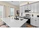 Bright kitchen with gray cabinets, stainless steel appliances, and modern fixtures is move-in ready at 3036 Parrot Head Pl, Kissimmee, FL 34747