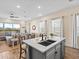Modern kitchen island with a sink offers seamless flow to the dining and living areas with great views at 3036 Parrot Head Pl, Kissimmee, FL 34747
