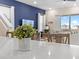 Open-concept kitchen features a quartz counter, a plant, and an accent wall in the background at 3036 Parrot Head Pl, Kissimmee, FL 34747
