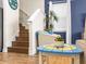 Coastal-themed living room with staircase, blue accent wall, and compass-themed side table at 3036 Parrot Head Pl, Kissimmee, FL 34747