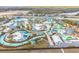 Expansive aerial shot of a water park with thrilling slides, lazy rivers, and various recreational water features at 3036 Parrot Head Pl, Kissimmee, FL 34747