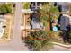 Aerial view of a home with well-maintained landscaping, nearby streets, and a glimpse of a community pool in the area at 3403 Canute Pl, Orlando, FL 32818