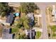An aerial view showcasing a home with a pool and proximity to neighborhood streets at 3403 Canute Pl, Orlando, FL 32818