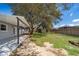 View of a large backyard featuring a covered patio, mature trees, and a storage shed, perfect for outdoor enjoyment at 3403 Canute Pl, Orlando, FL 32818