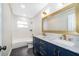 Stylish bathroom features a double vanity, marble countertop, and modern gold fixtures at 3403 Canute Pl, Orlando, FL 32818