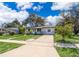 A single-story home with a well-manicured front yard and a concrete driveway at 3403 Canute Pl, Orlando, FL 32818