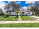 Charming single-story home featuring a landscaped front yard and a welcoming entrance at 3403 Canute Pl, Orlando, FL 32818