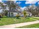 Charming home with well-manicured lawn and mature landscaping, presenting a warm and inviting curb appeal in a friendly neighborhood at 3403 Canute Pl, Orlando, FL 32818