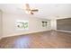 Bright open-concept living room with wood-look floors, fresh paint, and updated lighting fixtures at 3403 Canute Pl, Orlando, FL 32818