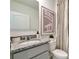 Well-lit bathroom featuring a granite countertop, updated vanity, and patterned shower curtain at 3438 Briarwood Grove Dr, Ocoee, FL 34761