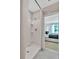 Modern bathroom featuring a stand-up shower and a view to the main bedroom at 3438 Briarwood Grove Dr, Ocoee, FL 34761