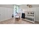 Cozy Bedroom with board and batten walls, chair/ottoman, and a charming crib at 3438 Briarwood Grove Dr, Ocoee, FL 34761