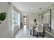 Bright dining area features a table with seating for six, large windows, and decor that enhances the room's modern appeal at 3438 Briarwood Grove Dr, Ocoee, FL 34761