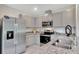 Sleek kitchen features stainless steel appliances, granite countertops, and ample cabinet space for modern convenience at 3438 Briarwood Grove Dr, Ocoee, FL 34761