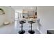 Modern kitchen features gray cabinets, granite countertops, stainless steel appliances, and a breakfast bar with seating at 3438 Briarwood Grove Dr, Ocoee, FL 34761