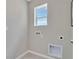 Neutral laundry room with tiled floors, window, and utility connections at 3438 Briarwood Grove Dr, Ocoee, FL 34761