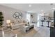 Open-concept living area with a modern kitchen, breakfast bar, and comfortable seating, perfect for entertaining at 3438 Briarwood Grove Dr, Ocoee, FL 34761