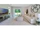 Comfortable living room with a large television, modern furniture, and a sliding glass door to the backyard at 3438 Briarwood Grove Dr, Ocoee, FL 34761