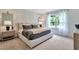 Relaxing main bedroom with a comfortable bed, stylish nightstands, and a view to the outdoors at 3438 Briarwood Grove Dr, Ocoee, FL 34761