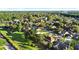 Picturesque aerial shot showcases homes, lush greenery, and a serene community lake at 3499 Woodley Park Pl, Oviedo, FL 32765