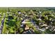 Aerial view showing neighborhood with tree-lined streets, lawns and nearby open green spaces at 3499 Woodley Park Pl, Oviedo, FL 32765