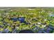 Gorgeous aerial view of a community with lush greenery, serene lakes, and a fountain feature at 3499 Woodley Park Pl, Oviedo, FL 32765