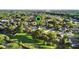 Overhead shot of a lush neighborhood with a map marker highlighting a home with a pool at 3499 Woodley Park Pl, Oviedo, FL 32765