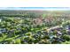 Beautiful aerial view of a neighborhood with lush trees and well-maintained lawns bathed in sunlight at 3499 Woodley Park Pl, Oviedo, FL 32765