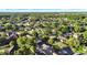 Aerial photograph showing tree-filled neighborhood with lawns, nearby pond and streets at 3499 Woodley Park Pl, Oviedo, FL 32765