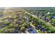 An expansive aerial captures a residential area rich in trees and featuring well-kept streets at 3499 Woodley Park Pl, Oviedo, FL 32765