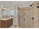 Bright bathroom features a glass enclosed shower and granite vanity with lots of natural light from glass block window at 3499 Woodley Park Pl, Oviedo, FL 32765