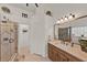 Bright bathroom with walk-in shower, wooden vanity, and neutral tile flooring at 3499 Woodley Park Pl, Oviedo, FL 32765