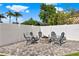 Outdoor stone firepit with patio and comfortable seating, surrounded by a well-maintained backyard at 3499 Woodley Park Pl, Oviedo, FL 32765