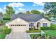 Charming single-story residence featuring manicured landscaping, lush green lawn, and practical attached garage with driveway at 3499 Woodley Park Pl, Oviedo, FL 32765