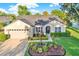 Well-maintained single-story home showcasing manicured landscaping, an inviting entrance, and attached garage at 3499 Woodley Park Pl, Oviedo, FL 32765