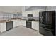 Modern kitchen featuring stainless steel appliances, granite countertops, and white cabinetry at 3499 Woodley Park Pl, Oviedo, FL 32765
