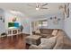 Comfortable living room with hardwood floors, a cozy sectional sofa, and a fireplace with a mounted TV at 3499 Woodley Park Pl, Oviedo, FL 32765