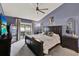 Spacious main bedroom with dark wood furniture and view to outdoor dining area at 3499 Woodley Park Pl, Oviedo, FL 32765