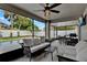 Screened in patio with ceiling fan, furniture, outdoor dining table, and access to the backyard pool at 3499 Woodley Park Pl, Oviedo, FL 32765
