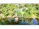 Aerial view of a gazebo on a pier with water lilies, tennis court, and lush greenery at 356 Remington Dr, Oviedo, FL 32765