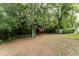 Private backyard features mature trees, a playset, and lush greenery at 356 Remington Dr, Oviedo, FL 32765