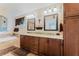 Elegant bathroom with double sinks, granite countertop, custom cabinets, and soaking tub with decorative tile at 356 Remington Dr, Oviedo, FL 32765