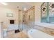 Well-appointed bathroom including a glass shower, soaking tub, and decorative tile at 356 Remington Dr, Oviedo, FL 32765