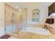 Spa-like bathroom featuring a glass enclosed shower, soaking tub, and decorative accents at 356 Remington Dr, Oviedo, FL 32765