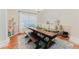Cozy dining room with a large wooden table, ample seating, and natural light from the window at 356 Remington Dr, Oviedo, FL 32765
