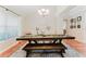 Inviting dining room featuring a large wooden table with bench seating and neutral decor at 356 Remington Dr, Oviedo, FL 32765
